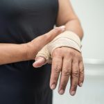 asian-middleaged-lady-woman-use-elastic-bandage-treating-de-quervain-syndrome-hand-finger-office.jpg