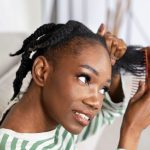 side-view-smiley-woman-combing-hair.jpg
